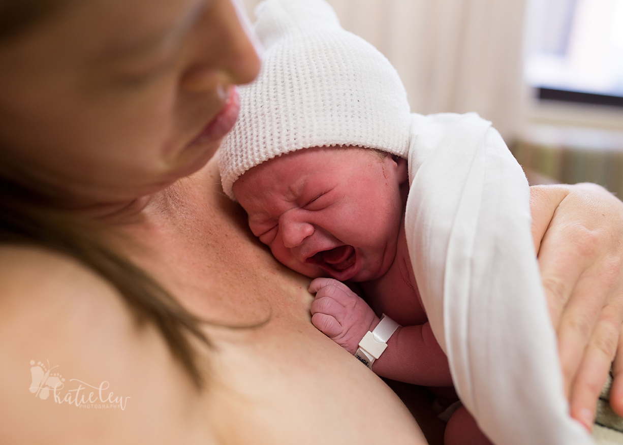 a baby crying on mom's chest right after her northern oklahoma birth