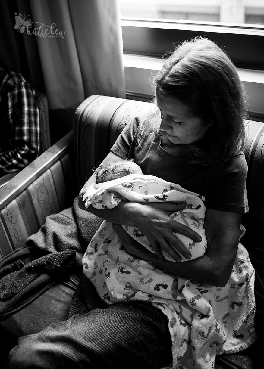 newborn being held by her grandmother