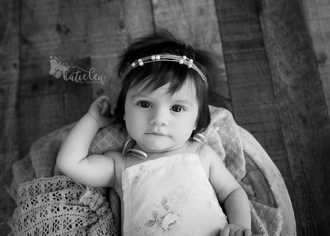 A black and white portrait of a baby girl 