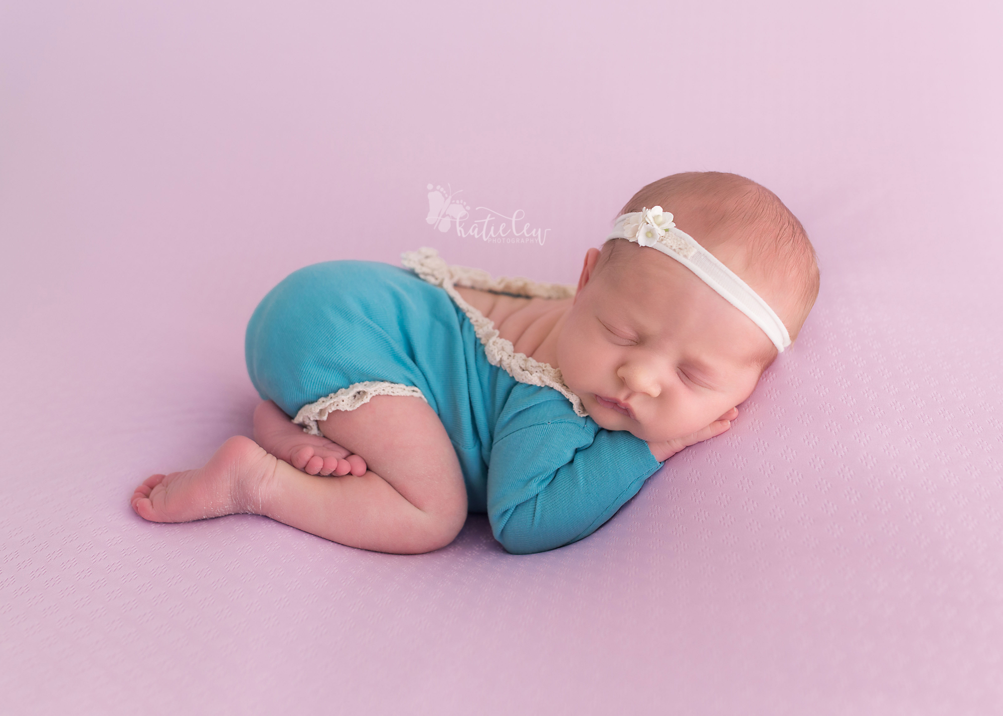 newborn girl in turquoise at a studio in stillwater, oklahoma.