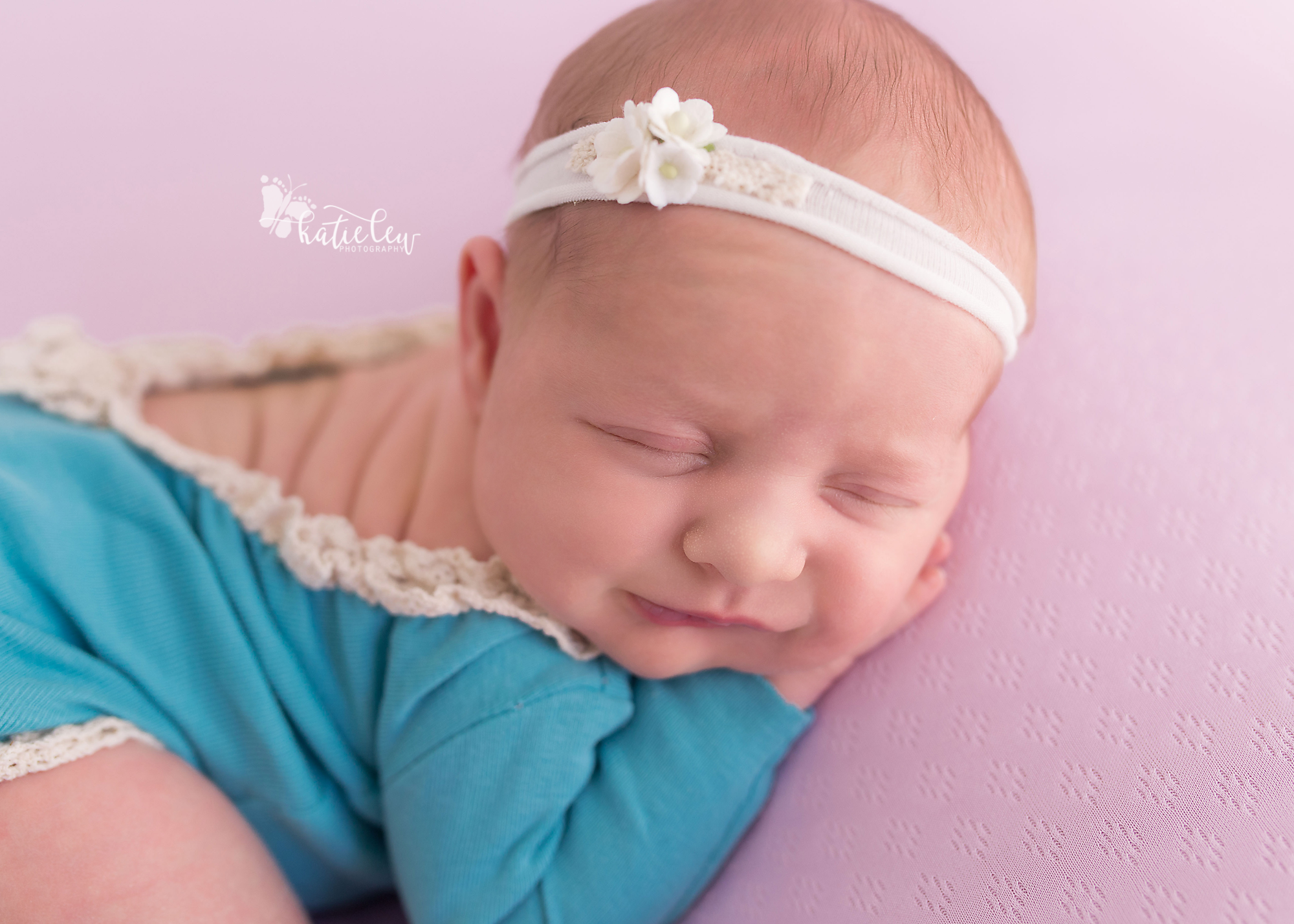 Smiling newborn girl.