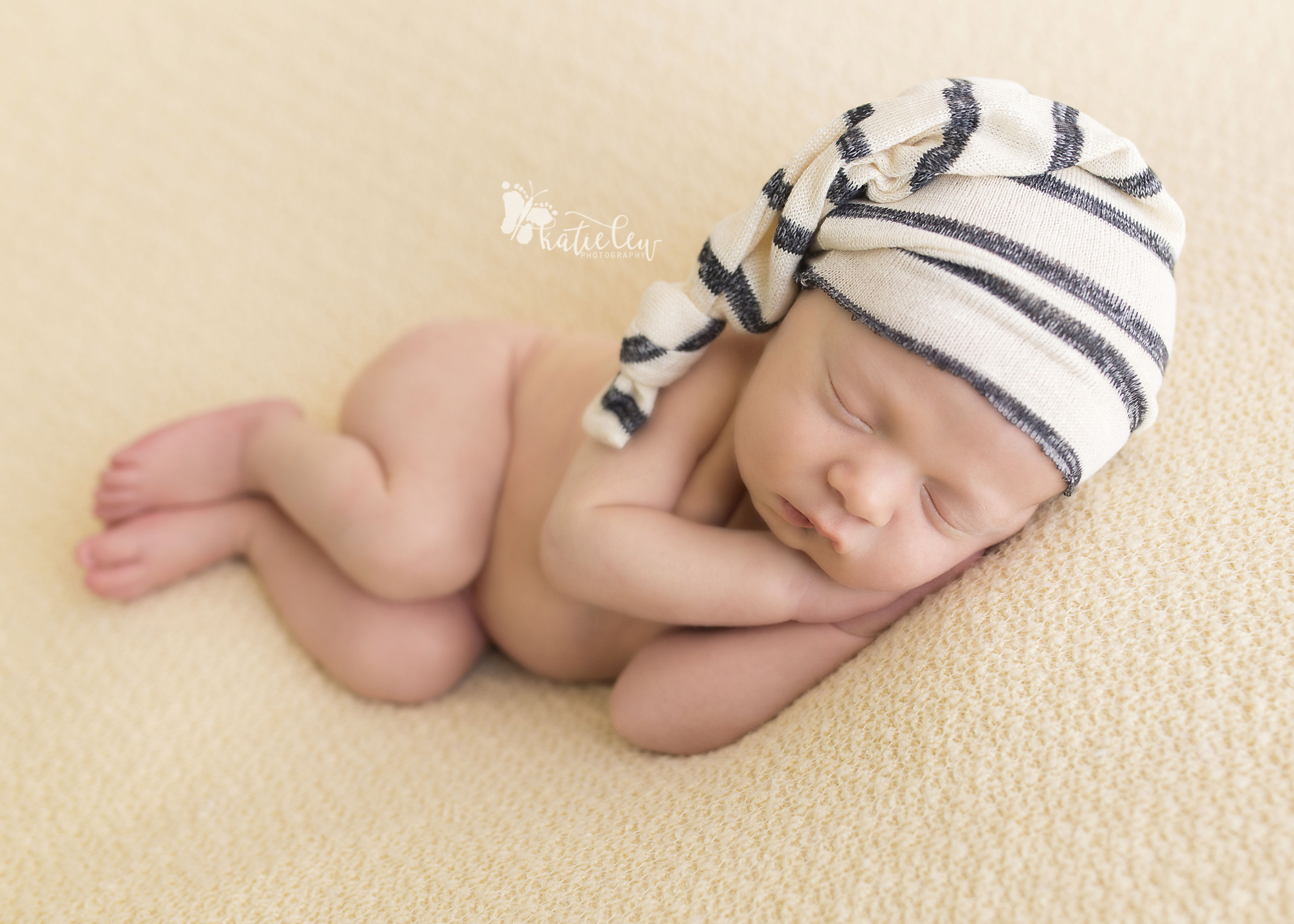 sleeping baby boy wearing a striped hat