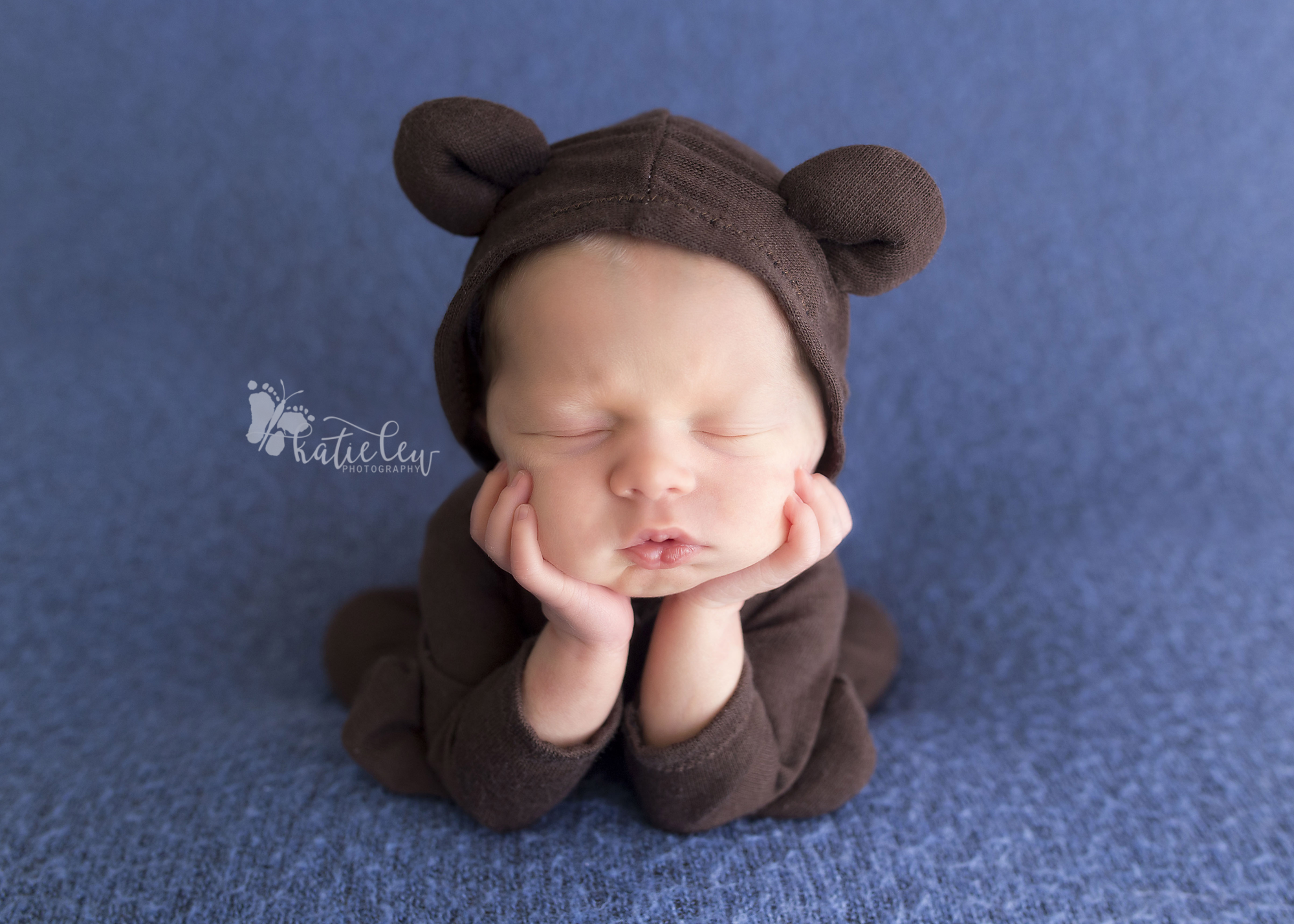 newborn baby dressed in an adorable teddy bear outfit