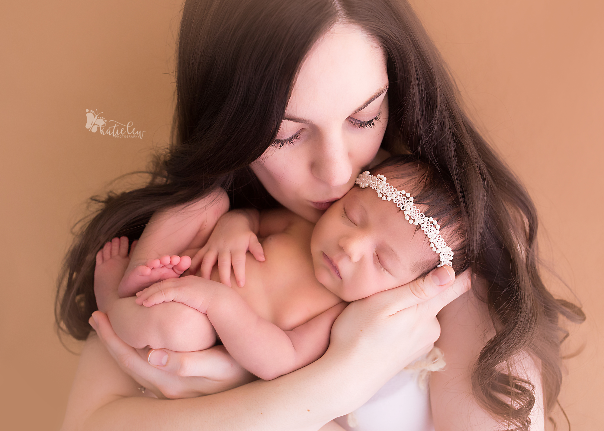 Mother kissing her brand new baby girl