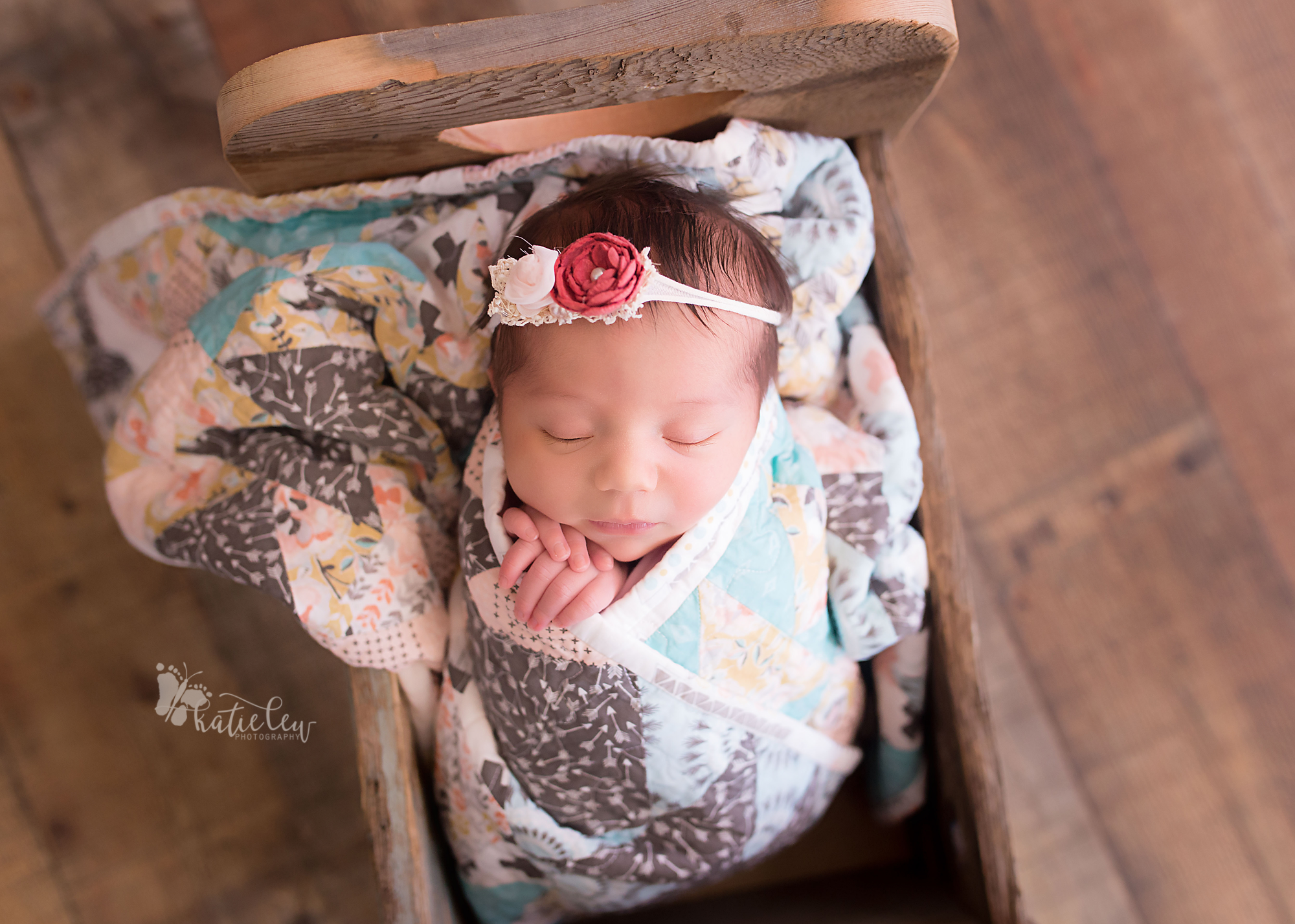 baby girl wrapped in a quilt
