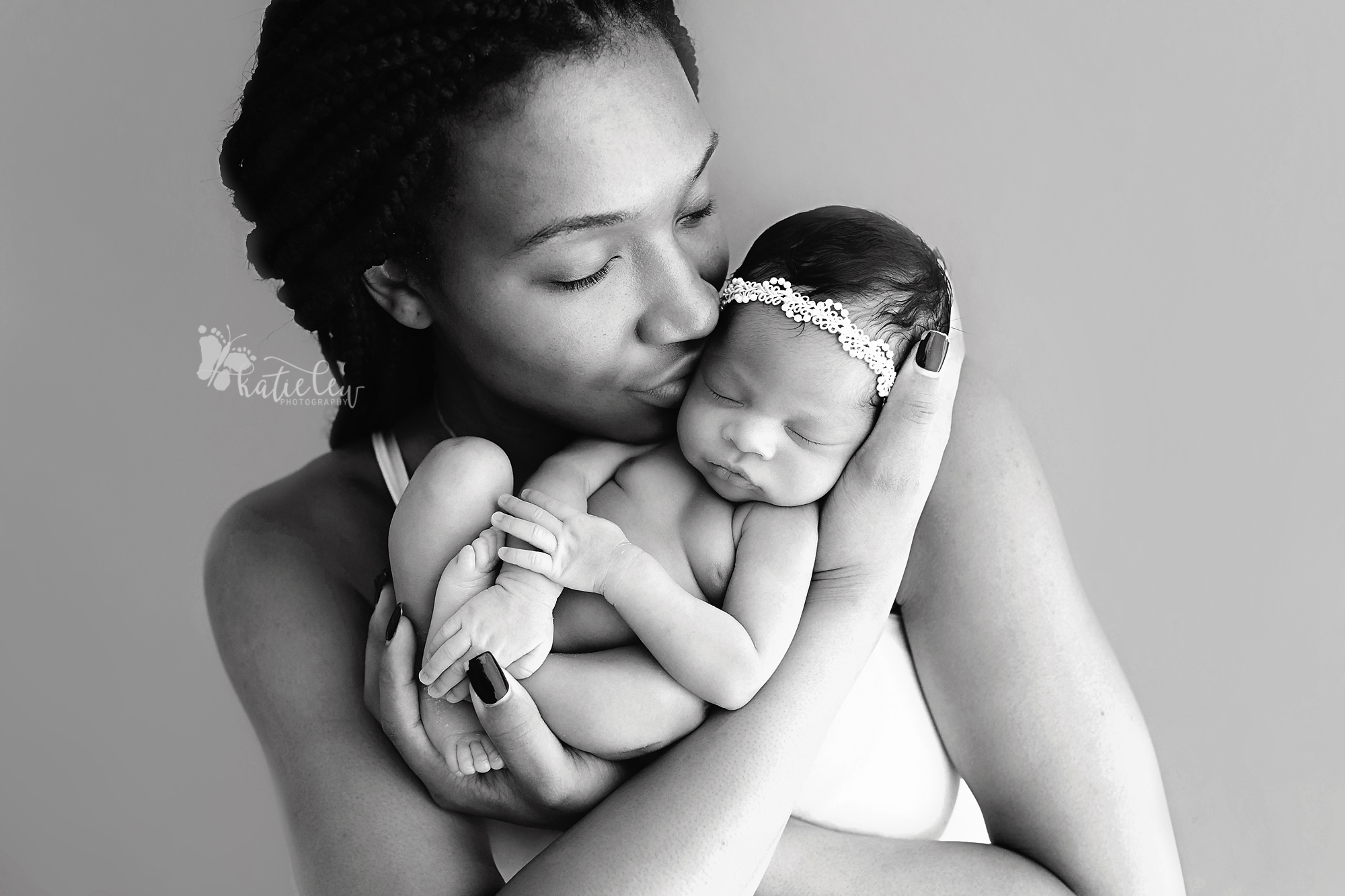 black and white image of a mother and her newborn