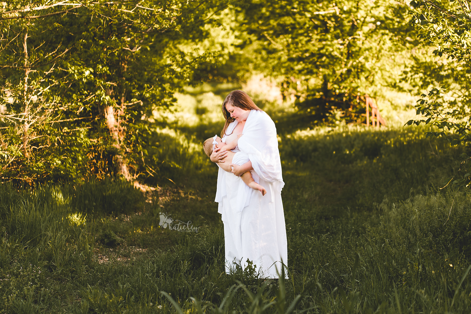 a mother dressed in white nurses her daughter