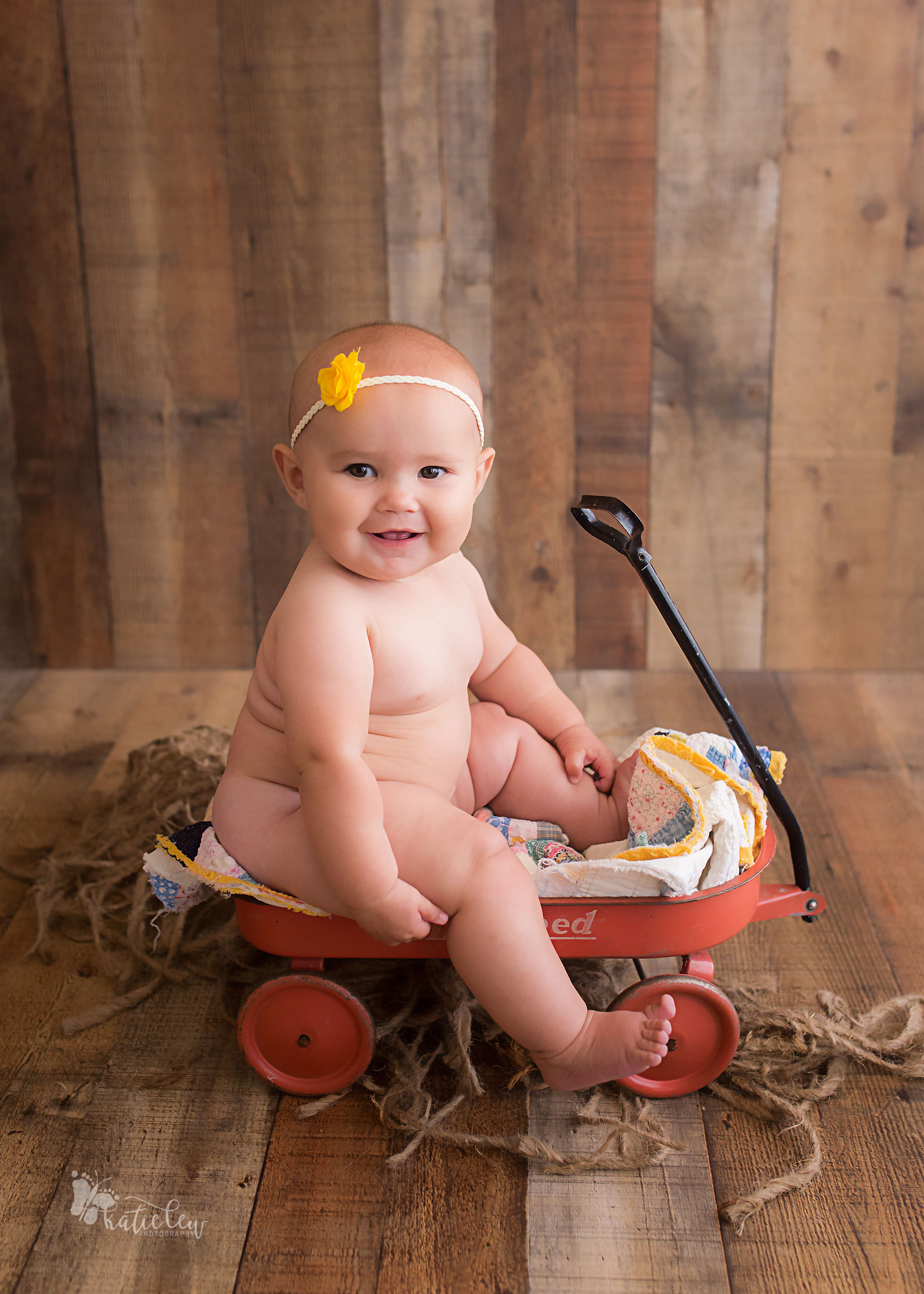 six month old baby girl in a cute wagon