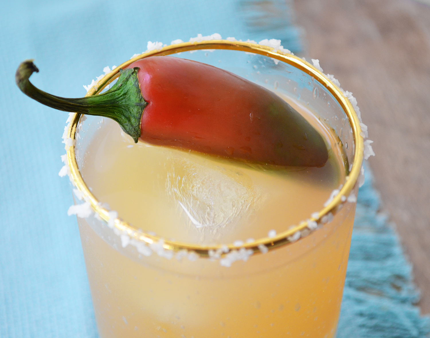 Paloma-Oh-My-Gawd 2 oz silver tequila 3 oz grapefruit juice 1 oz lime juice ½ oz maple simple syrup Sparkling water 2 jalapeños (1 for muddling, 1 for garnish) Sea salt for rim