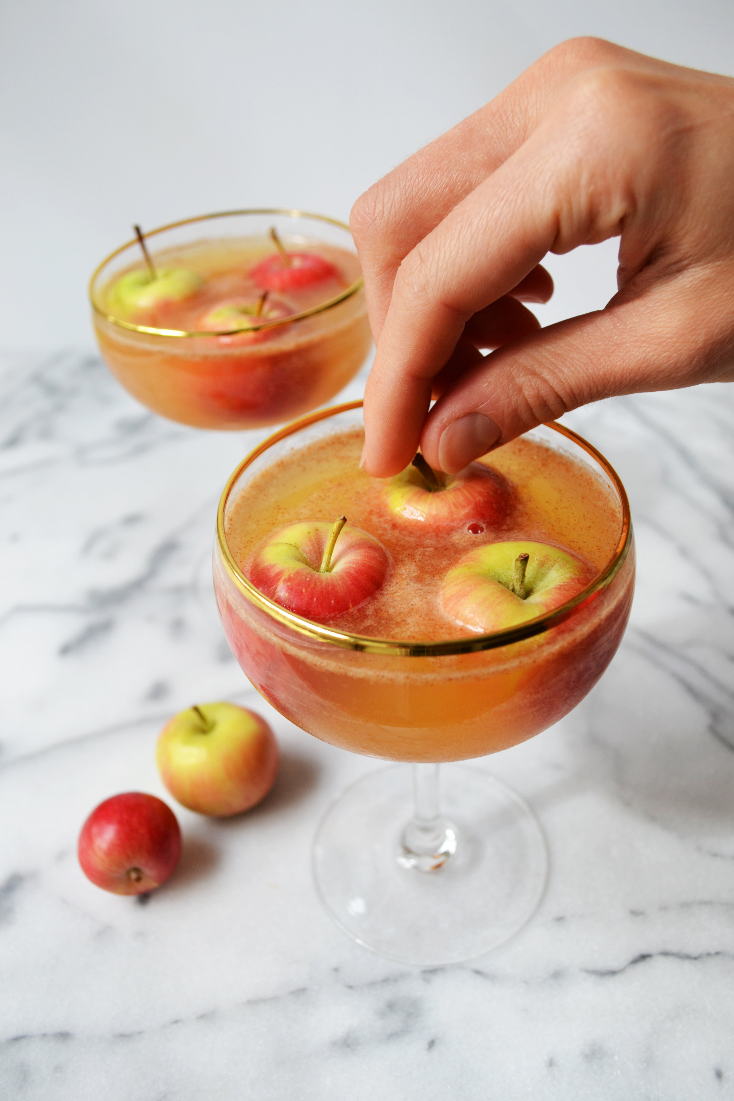 Bobbing for Apples 1.5 oz Bulleit Bourbon 1.5 oz apple juice ¼ oz simple syrup ¼ oz fresh lemon juice 1 pinch of cinnamon 3 tiny apples to garnish