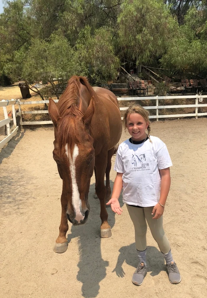 Lucie and Fiona enjoying some turnout. When Fiona first came to us, she was a sad and anxious soul. She had been passed around to different owners and riders and sent through numerous "training systems". Fiona was so out of emotional balance that she could not even enjoy her free time. Turnout, which should have been a relished and relaxing experience, made her nervous and even frantic. She would pace anxiously and have no awareness of people around her. Her angst was so great we felt it was potentially dangerous for Lucie to be in the arena with her during turnout. The tonic was time and careful listening. We began by giving her turnout in our small arena, where she felt safe and could see her human and equine cheerleaders. Once she was relaxed enough to start sunbathing regularly in the small arena, we offered her time in the large arena with one of us there to keep her company. These supervised turnouts have become rewarding for all of us, and Lucie is proud of the fun she and Fiona have practicing in hand work at liberty!