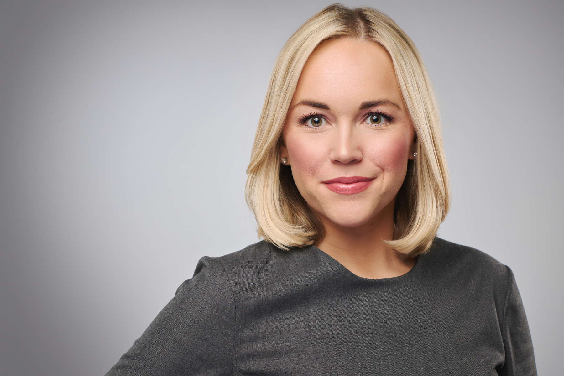 Nashville Headshot Photographer Blonde Woman photographed against a grey backdrop