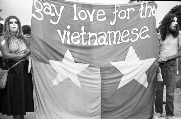 Demonstrators holding a “Gay Love for the Vietnamese” sign at an anti-war rally during the GOP Convention. Photographed by John Buckley.