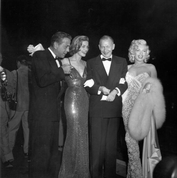 Wearing a Norman Norell sequin ‘Mermaid’ dress, Lauren Bacall sparkles next to Humphrey Bogart and Marilyn Monroe at the premiere of How To Marry A Millionaire on November 4, 1953 in Los Angeles.