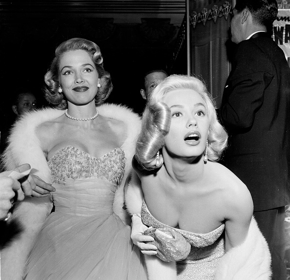 Glamour girls Sara Shane and Mamie Van Doren attending the premiere of The Glenn Miller Story in Los Angeles, December 10, 1953.