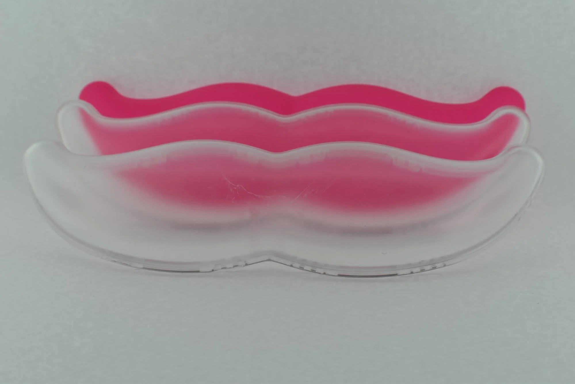 A progression of early shots of the Lyft Glowstache. Note some of the marks on the first model and the addition of color later on.