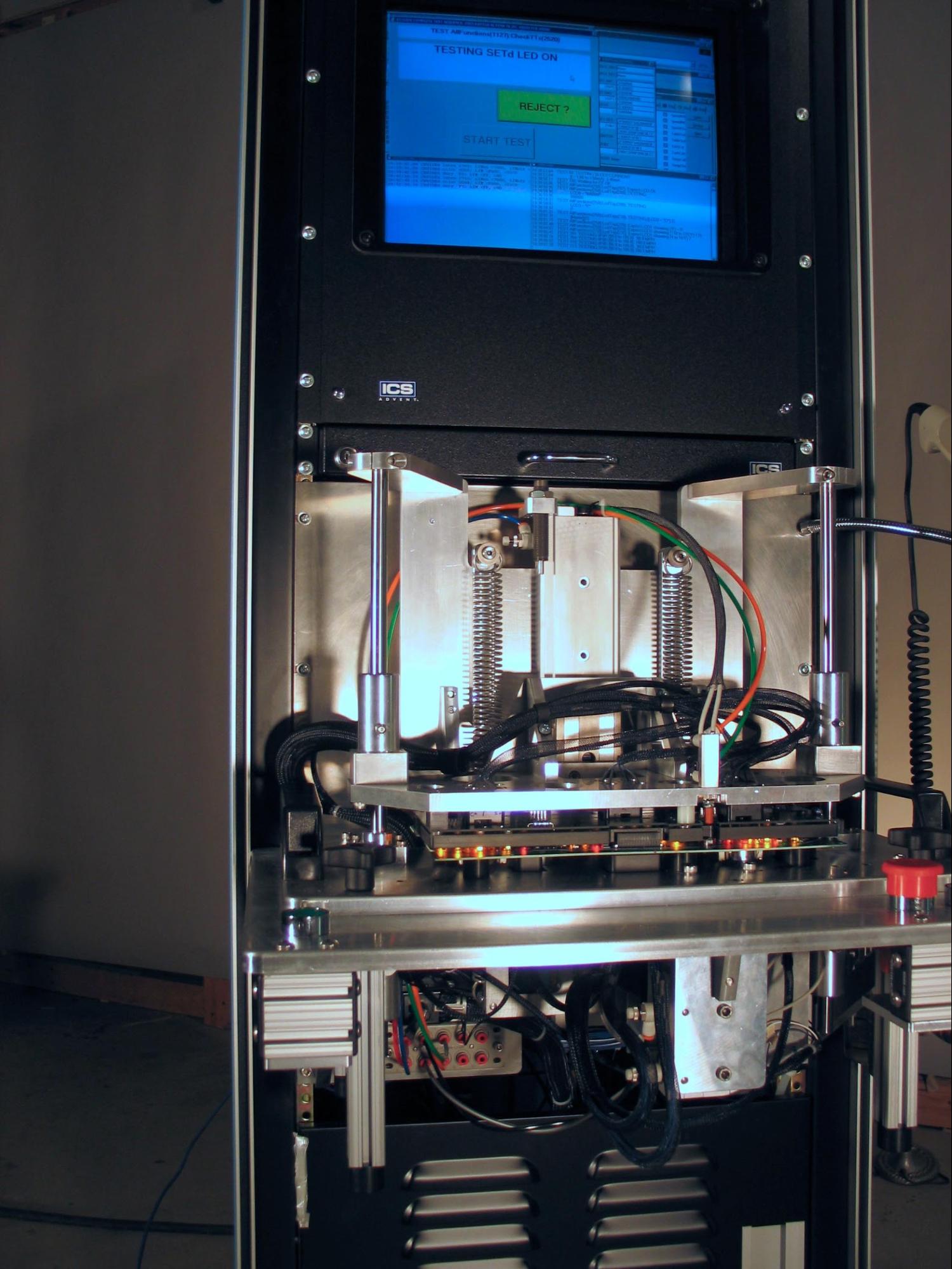 A test fixture measuring and validating LED color and brightness on a PCB ( source ).