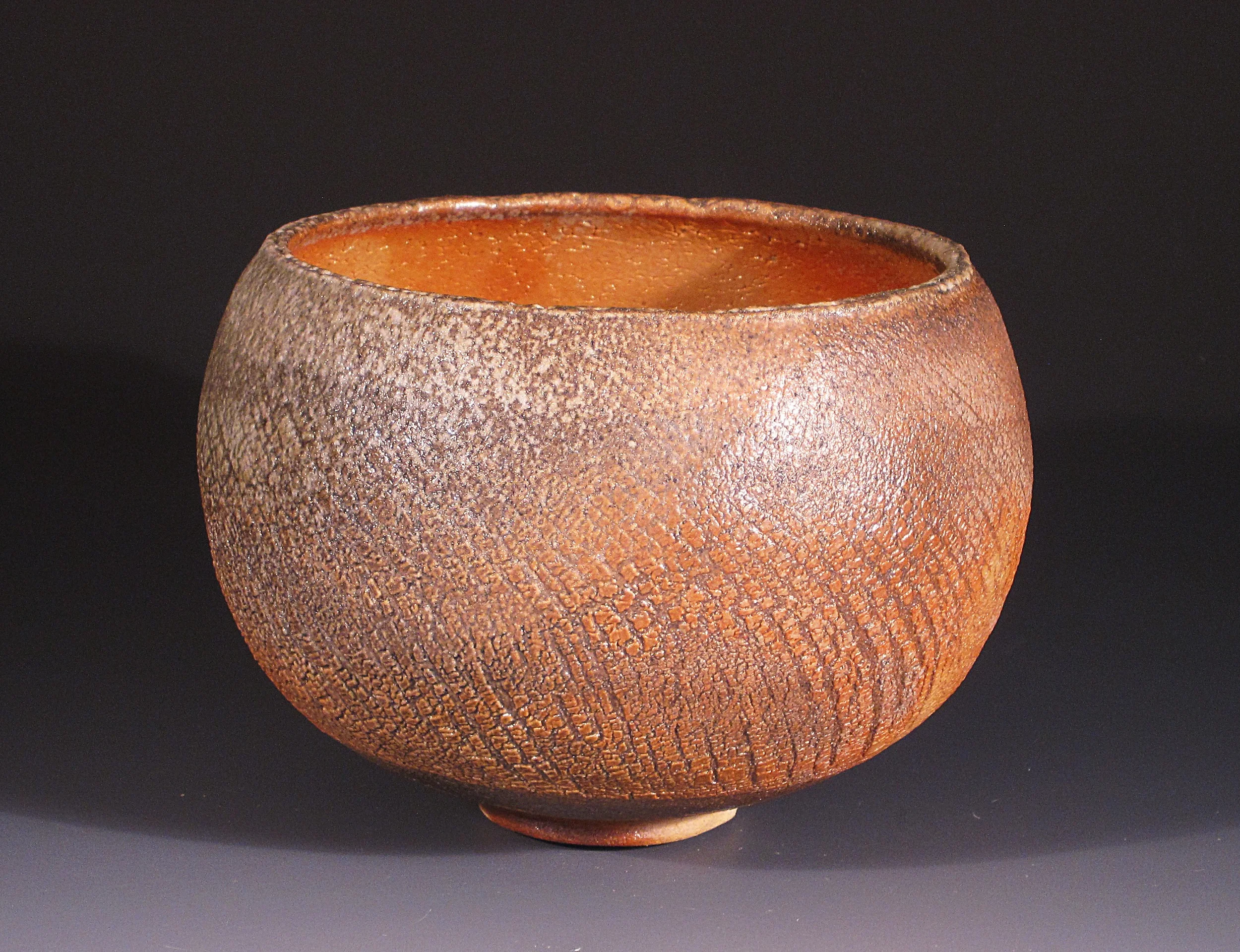Shino bowl, 4.5 x 6", glazed, then formed on the wheel from the inside to produce texture. 