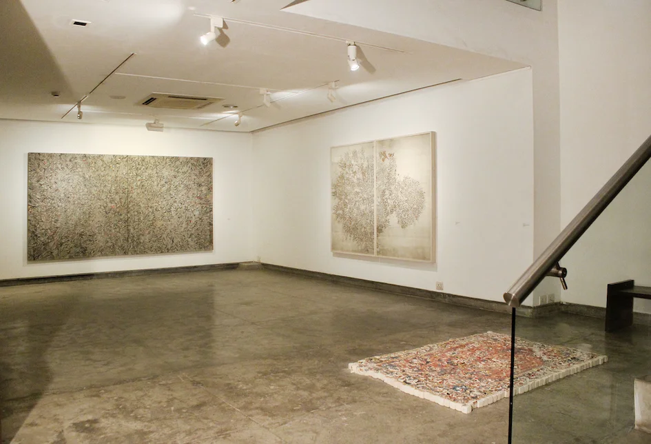 G R Iranna, “Ether is all that is”, 21 January – 9 March 2017, Gallery Espace, New Delhi. Installation view with ‘Psychic Sound’, 2016, acrylic on tarpaulin, 66 x 120 in (Left) and ‘Beautiful Burning Tree’, 2016, silver foil on paper 60 x 80 (Right). Image courtesy Gallery Espace.