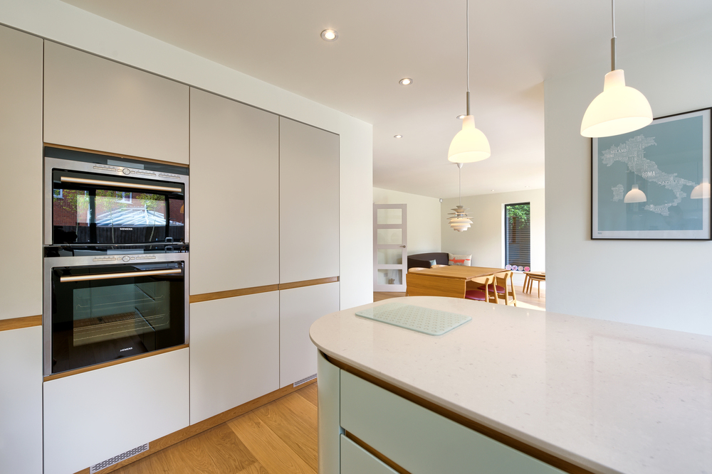 Kitchen counter and lighting of a Scandinavian house extension by Harvey Norman Architects Bishop's Stortford