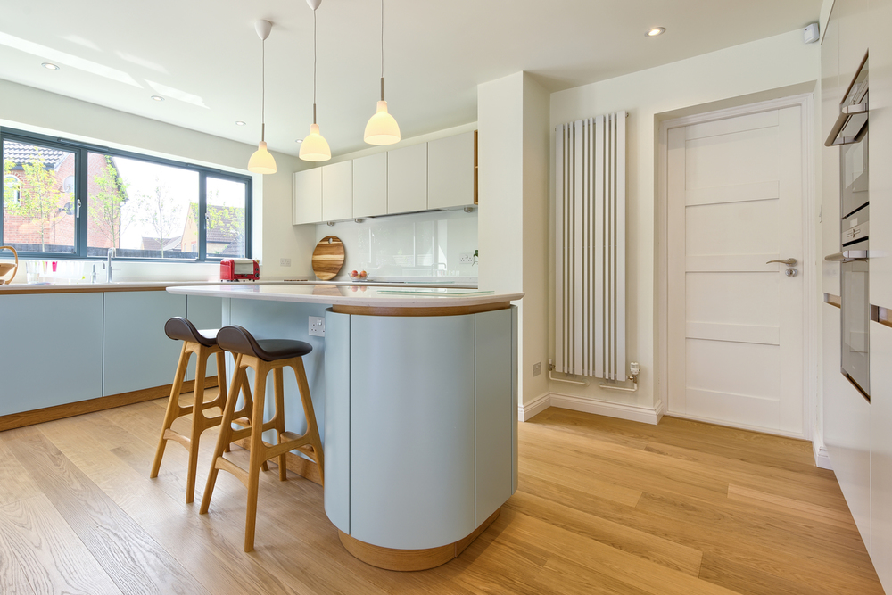 Breakfast bar and stools of a Scandinavian house extension by Harvey Norman Architects Bishop's Stortford