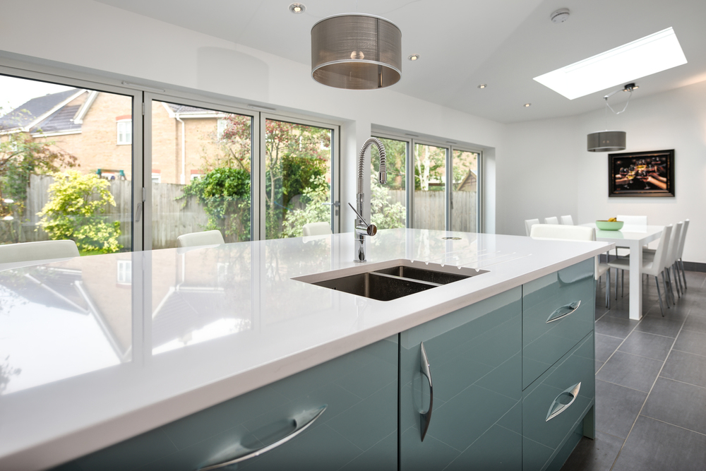 Island breakfast table with drawers of a lighting house extension by Harvey Norman Architects Cambridge