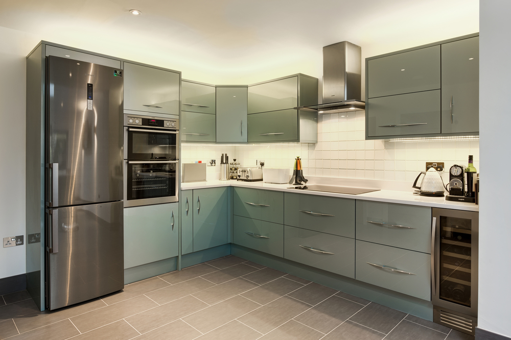 Appliances and cabinet view of a lighting house extension by Harvey Norman Architects Cambridge