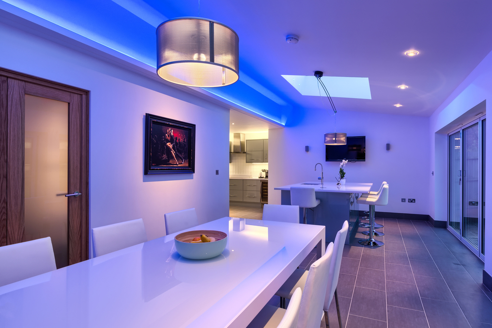 Breakfast bar blue light of a lighting house extension by Harvey Norman Architects Cambridge