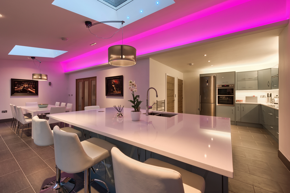 Purple light of a lighting house extension by Harvey Norman Architects Cambridge