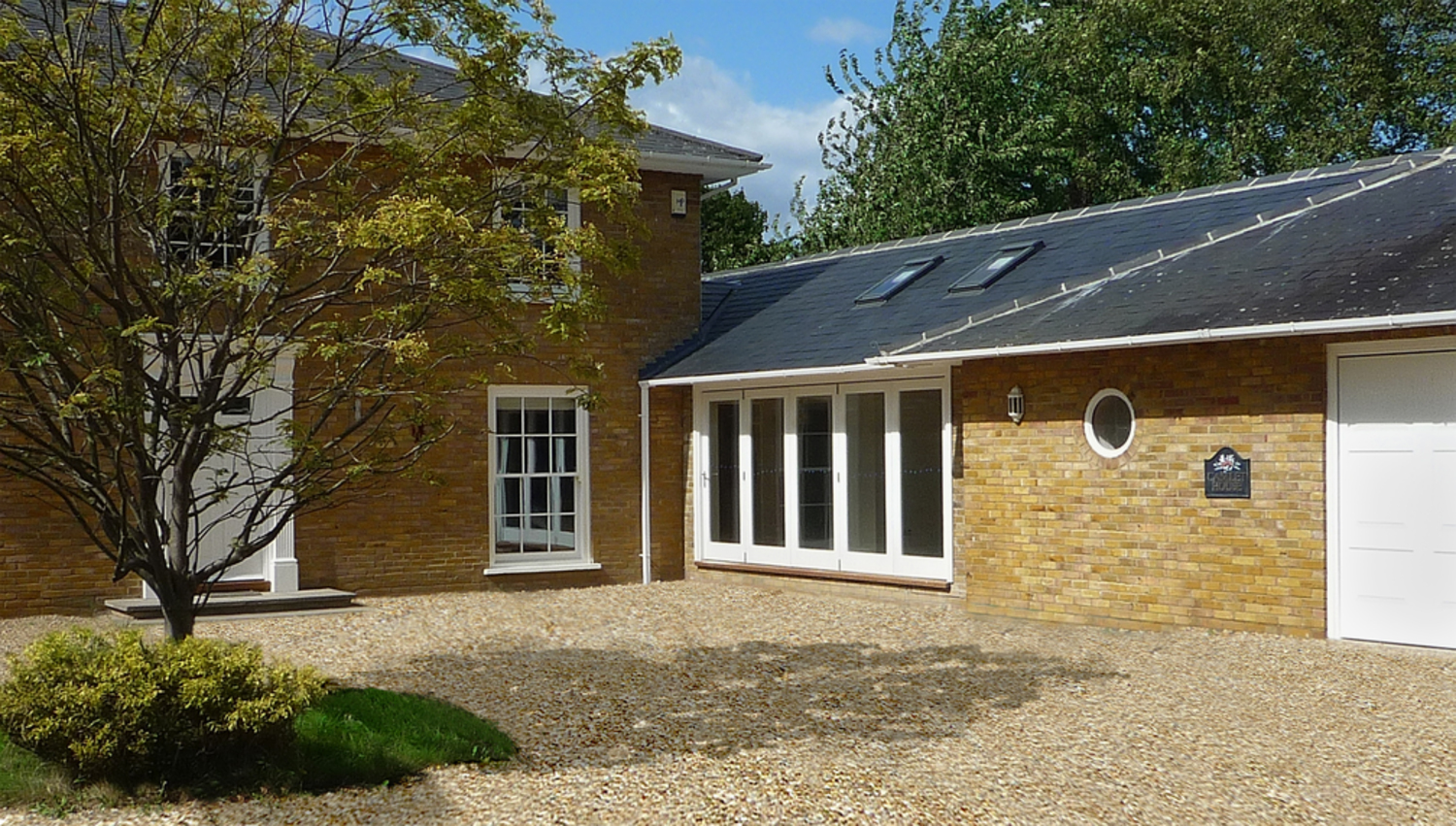 Driveway view of a house extension by Harvey Norman Architects Cambridge