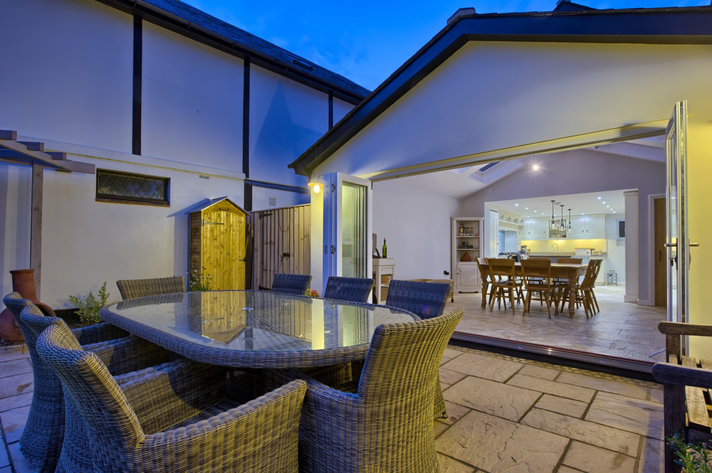 Garden reed chairs of a house redesign by Harvey Norman Architects Cambridge