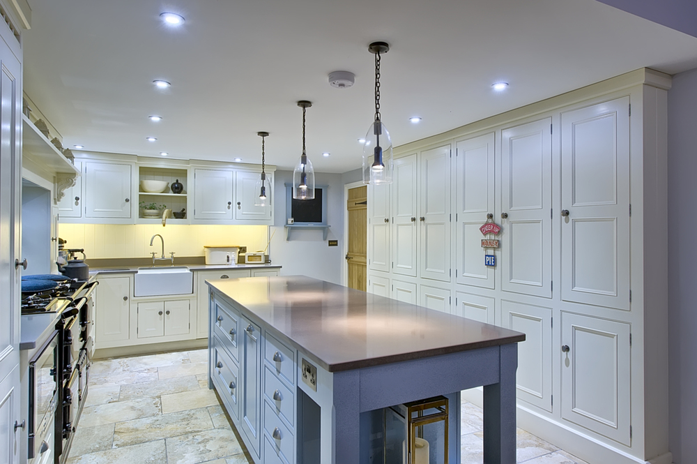 Kitchen island counter books of a house redesign by Harvey Norman Architects Cambridge