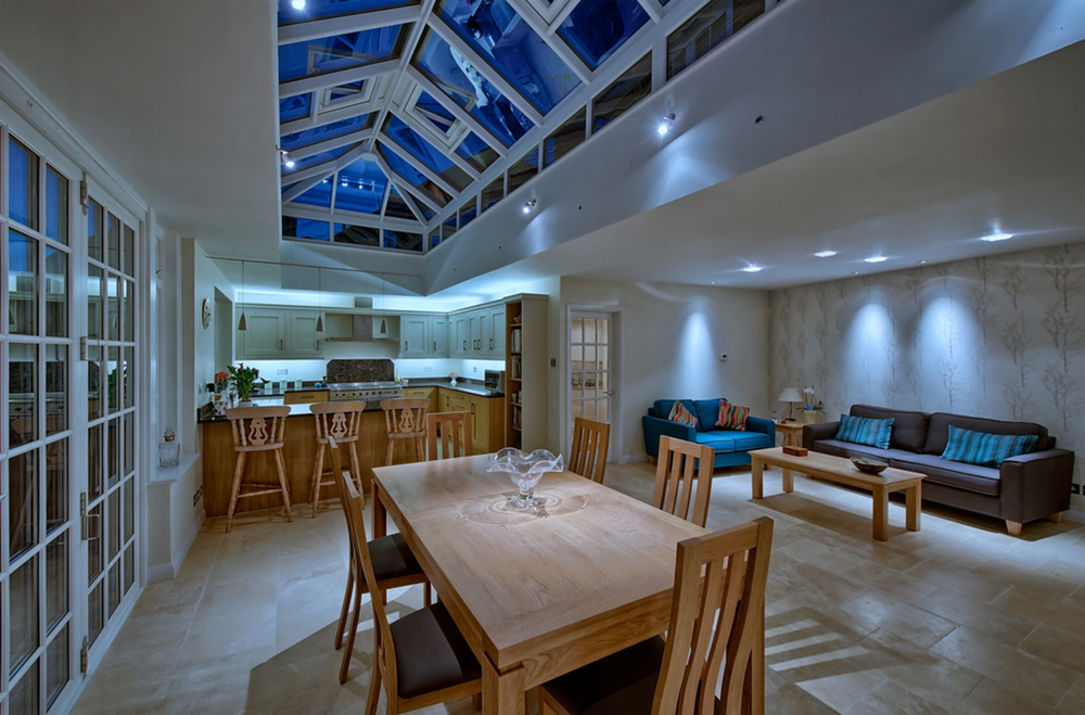 Dining room table night lighting of a house extension by Harvey Norman Architects St Albans