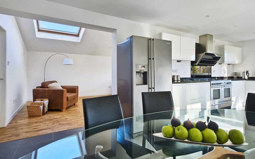 Spacious dining room of a house extension by Harvey Norman Architects Cambridge