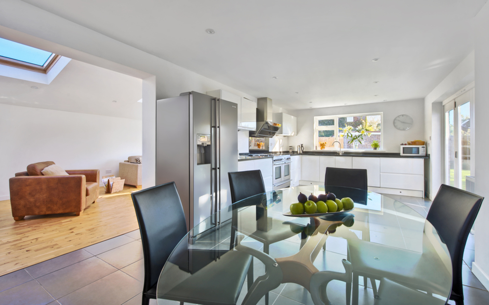 Glass dining room table of a house extension by Harvey Norman Architects Cambridge