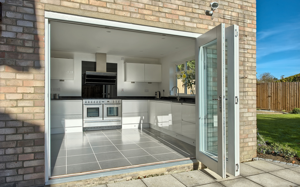 Sliding doors view into kitchen of a house extension by Harvey Norman Architects Cambridge