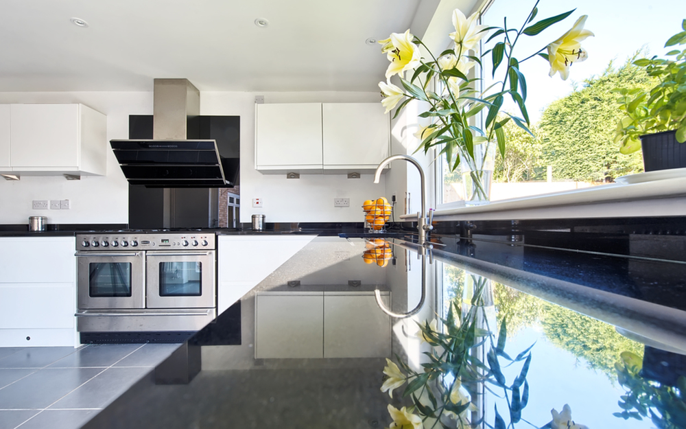 Kitchen counter and sink of a house extension by Harvey Norman Architects Cambridge