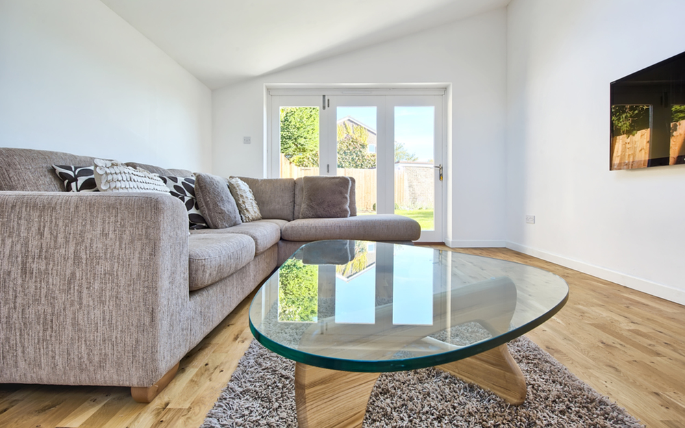 Sitting room coffee table of a house extension by Harvey Norman Architects Cambridge