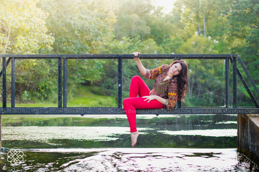 Senior girl on a bridge over the lake