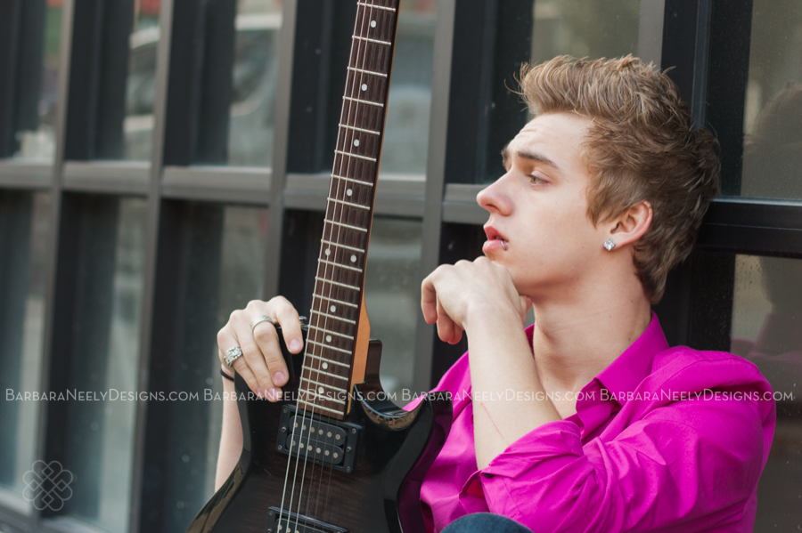 Senior guy on city street with guitar