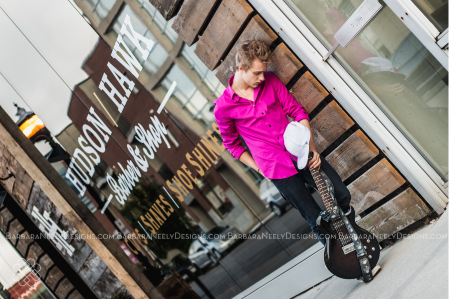 Senior guy on city street with guitar