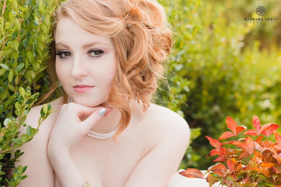 beautiful red haired senior girl in springtime foliage