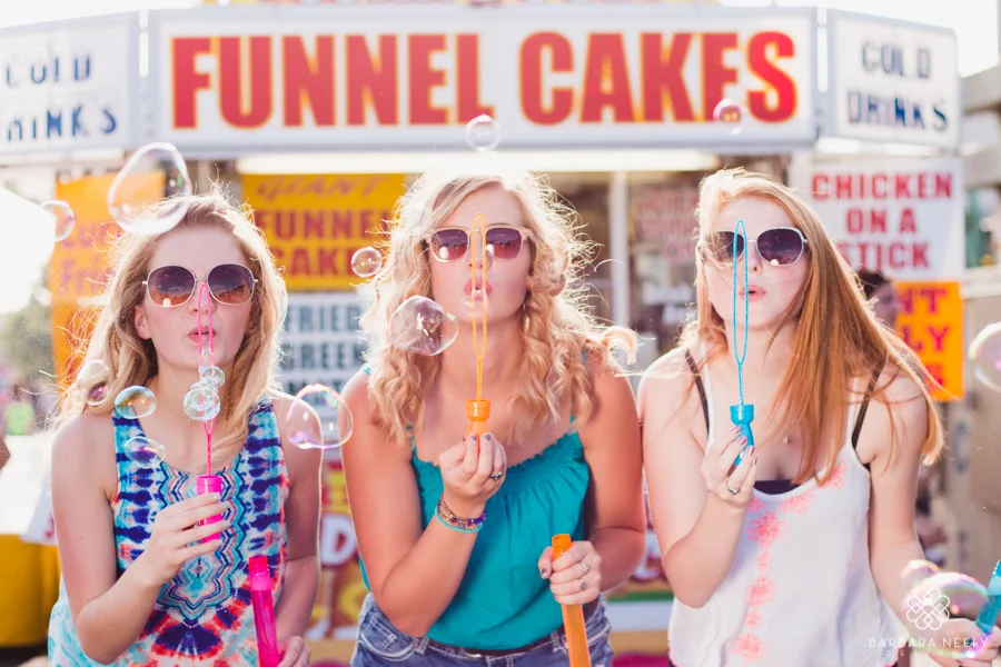 Senior girls blowing bubbles at the fair