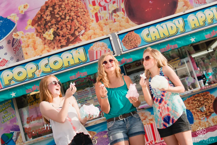 Senior girls eating cotton candy at the fair