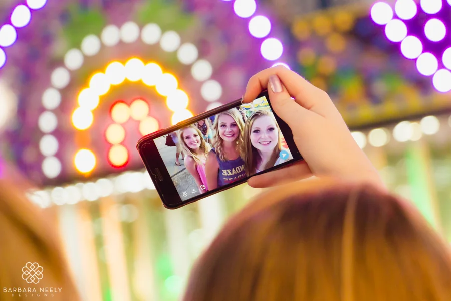 Senior girls taking a selfie at the fair