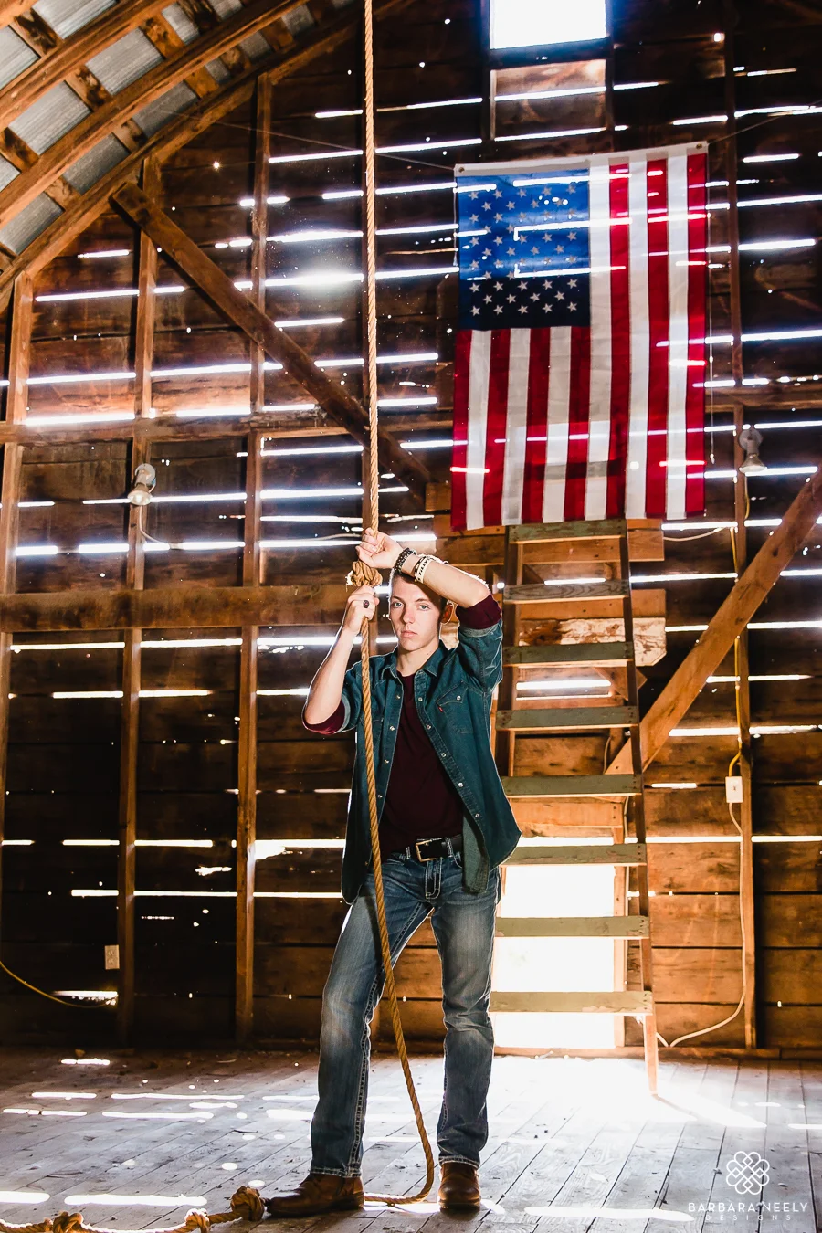Senior guy hanging out in barn loft with American flag