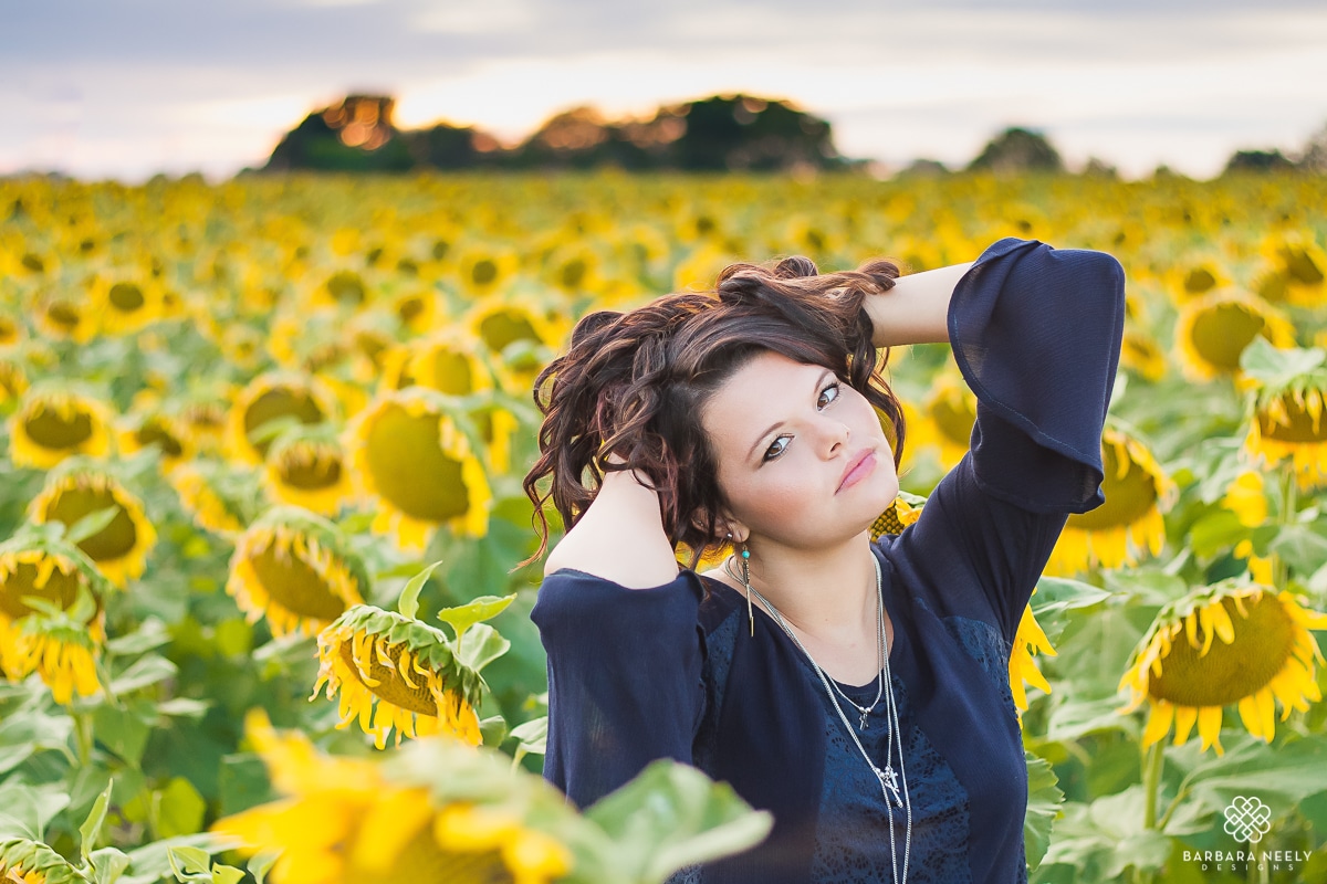 Stunning senior girl in a sunflower field