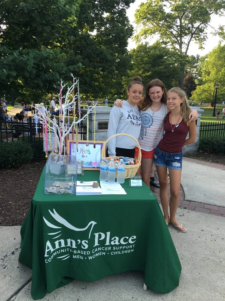 Kiralyse Hermann (left) and friends host an information/donation table at a community concert in Ridgefield's Ballard Park.