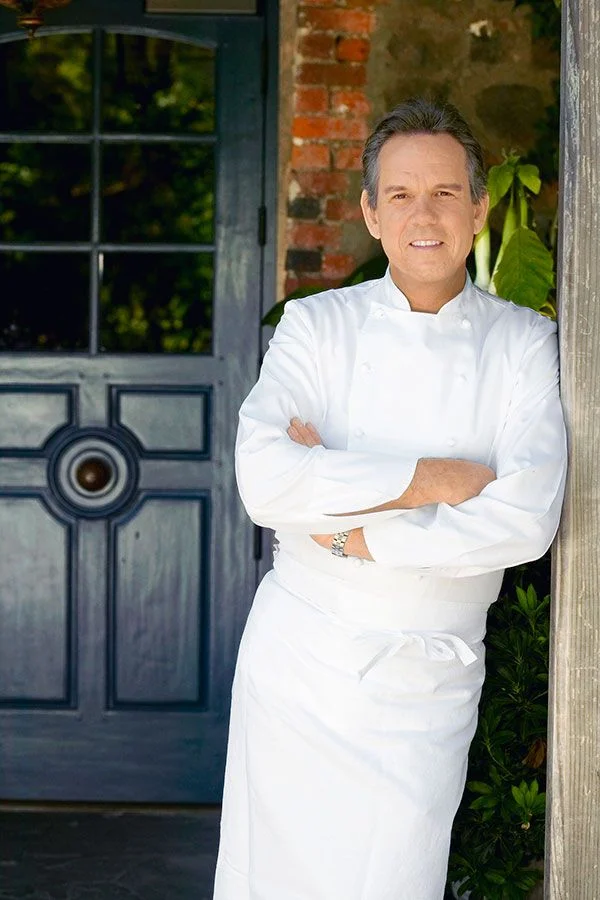  image by Deborah Jones Studio Chef Thomas Keller standing in front of the famous blue door of The French Laundry , that pays homage to the previous owners Don and Sally Schmitt's blue range hood. The color has inspired the restaurant's blue palette ever since.