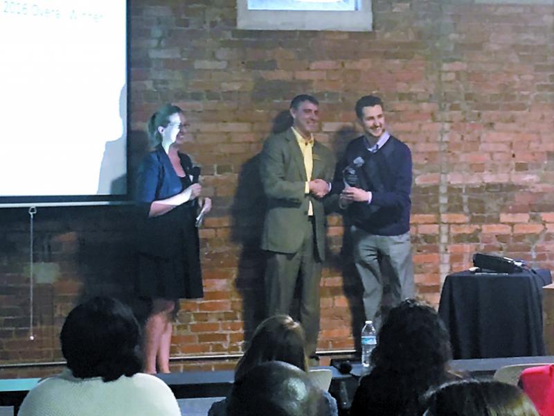 Trey Gordner, CEO/Cofounder of KOIOS, accepts the award at FastPitch image courtesy of Katie Martin and the Savannah Morning News